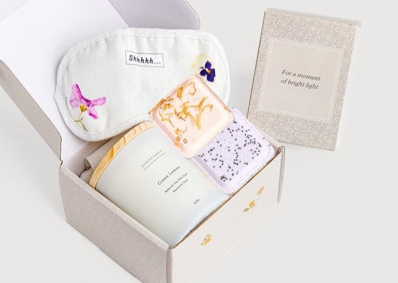 Green lemon spa gift box with glass scented candle, two shower steamers, and sleeping eye mask
