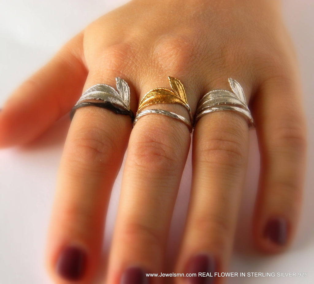 Gold and silver rose leaf ring crafted from real plant mold on a white background