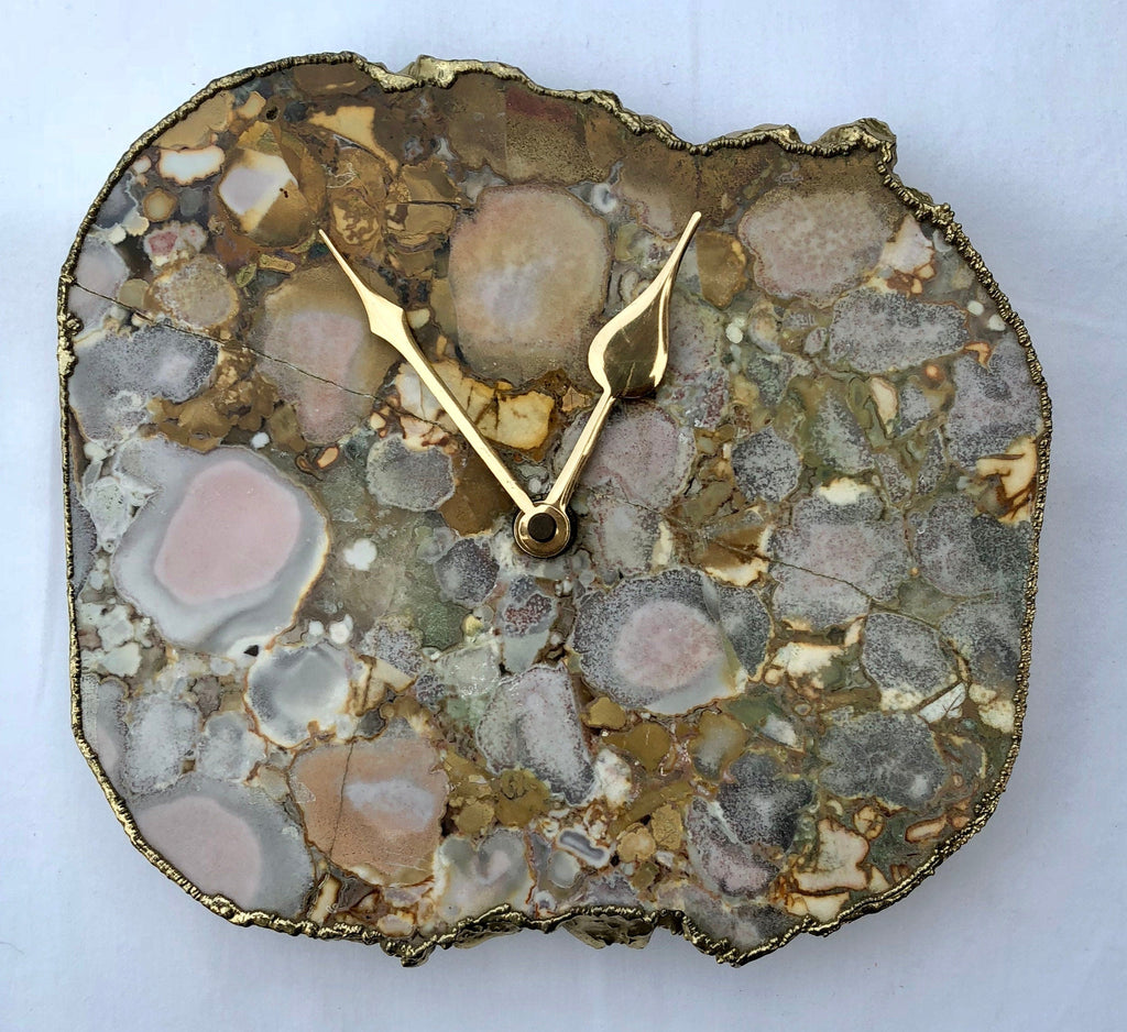 Conglomerate quartz desk clock with electroplated gold edges and brass hands on a metal base