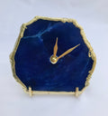 Indigo blue agate desk clock with metallic gold edges and modern brass hands on metal base