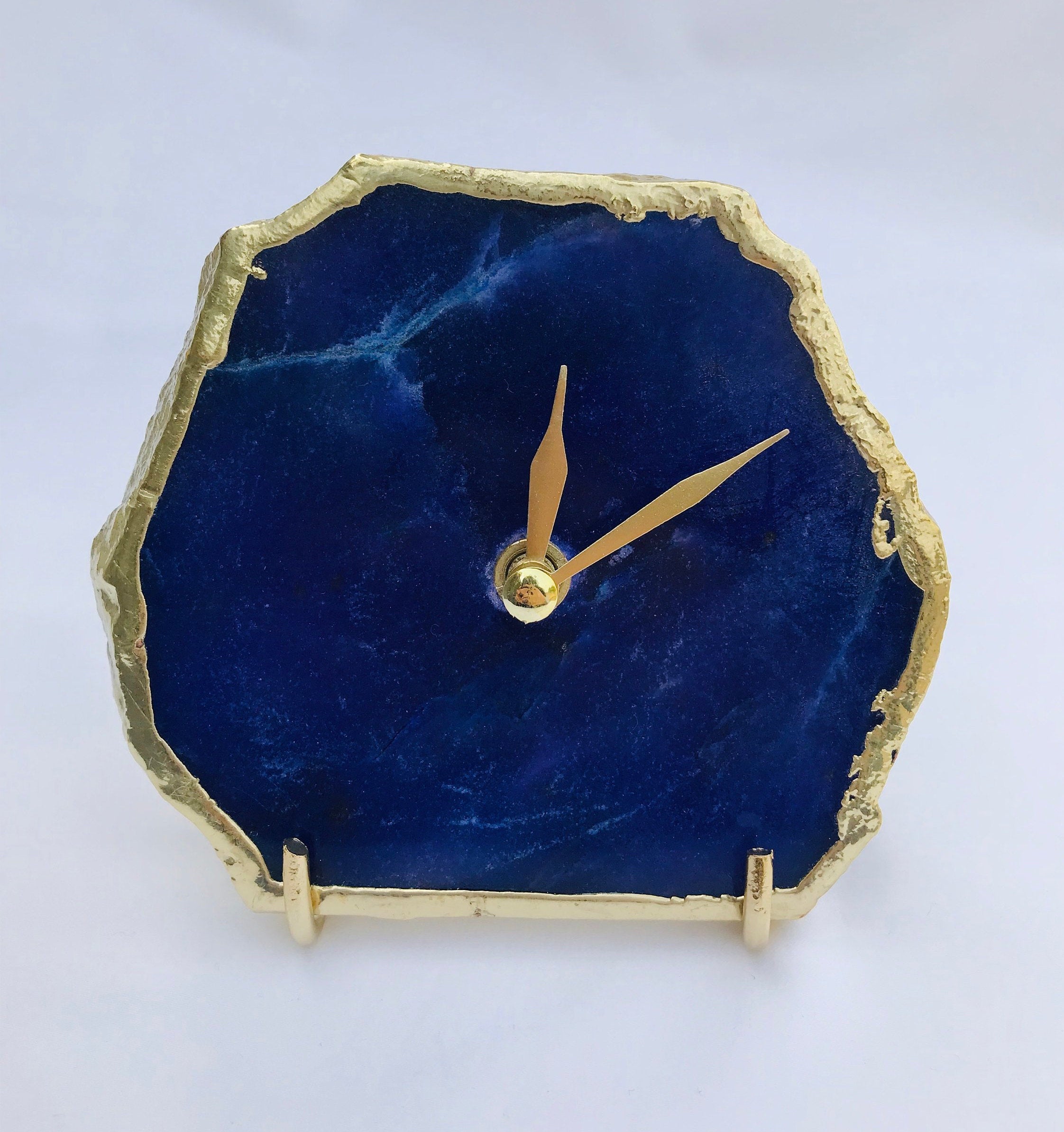 Indigo blue agate desk clock with metallic gold edges and modern brass hands on metal base