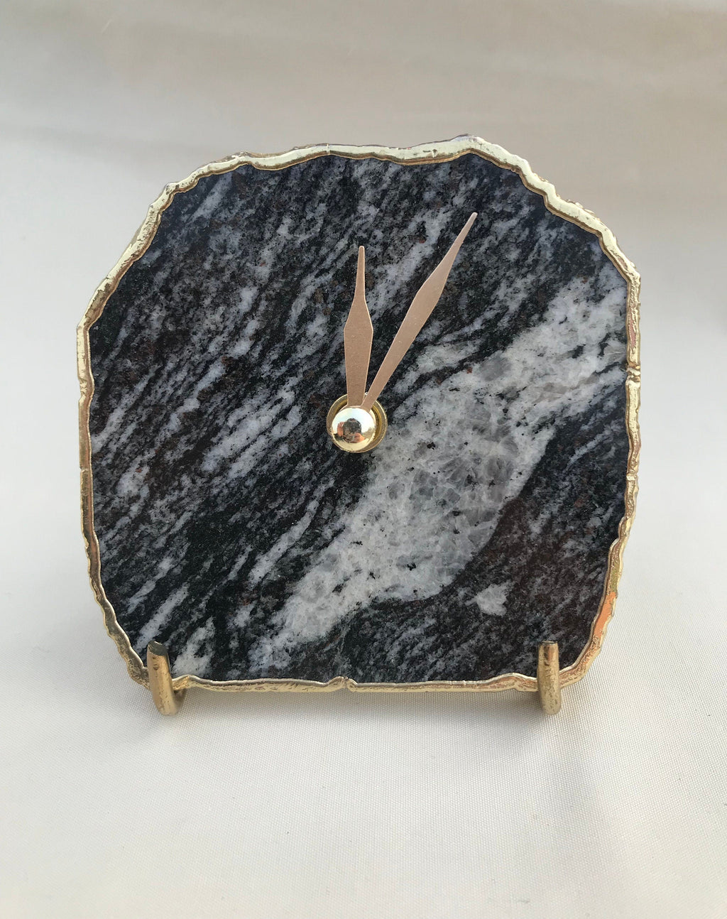 Black and white zebra agate desk clock with metallic gold edges and brass hands