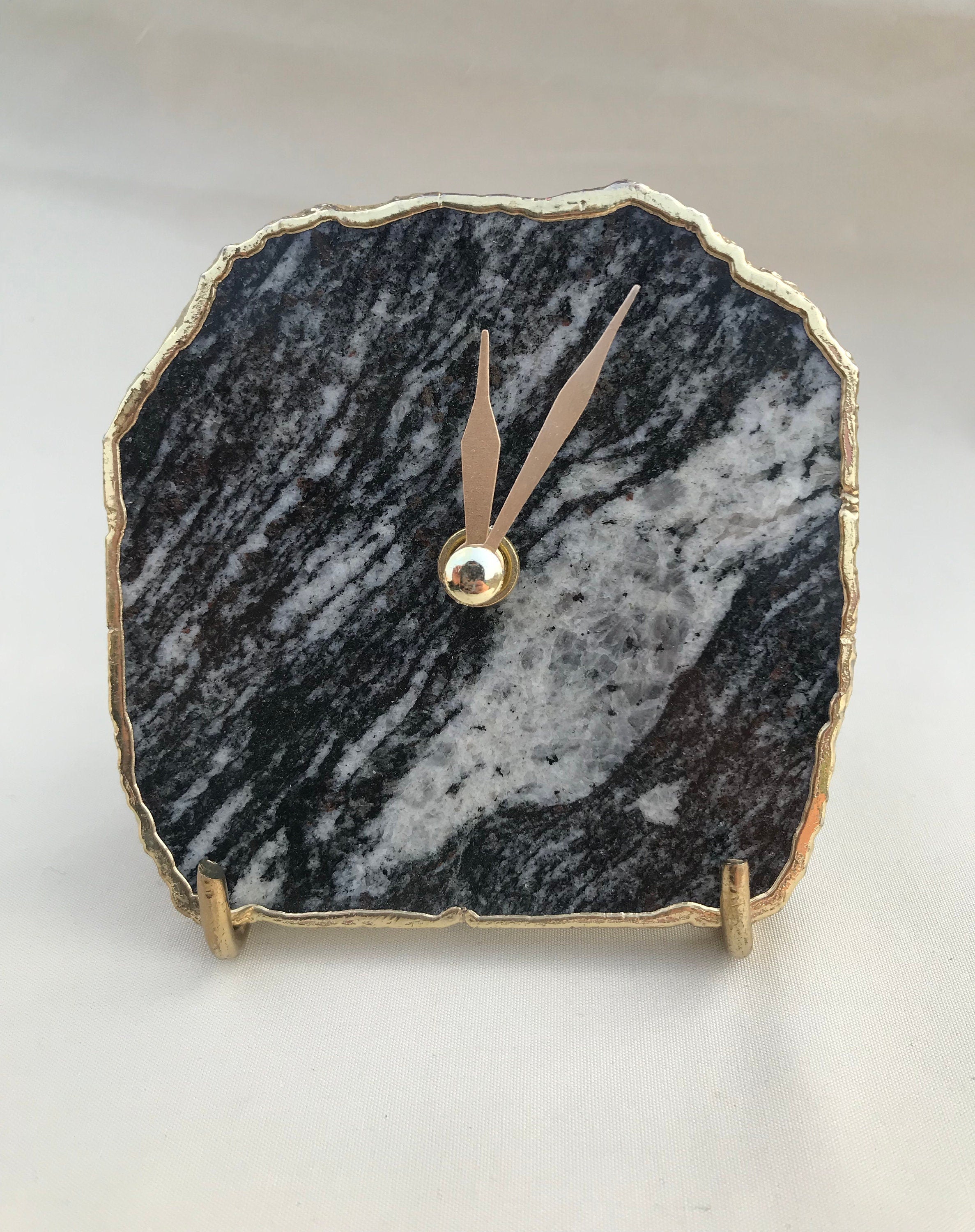 Black and white zebra agate desk clock with metallic gold edges and brass hands