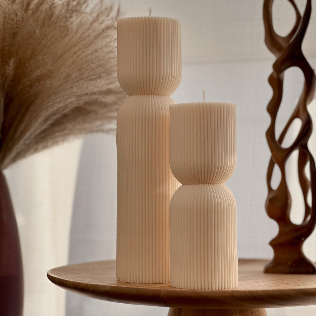 Hand-poured ribbed hourglass soy pillar candle showcasing minimalist sculptural design and natural cotton wicks