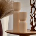 Hand-poured ribbed hourglass soy pillar candle showcasing minimalist sculptural design and natural cotton wicks