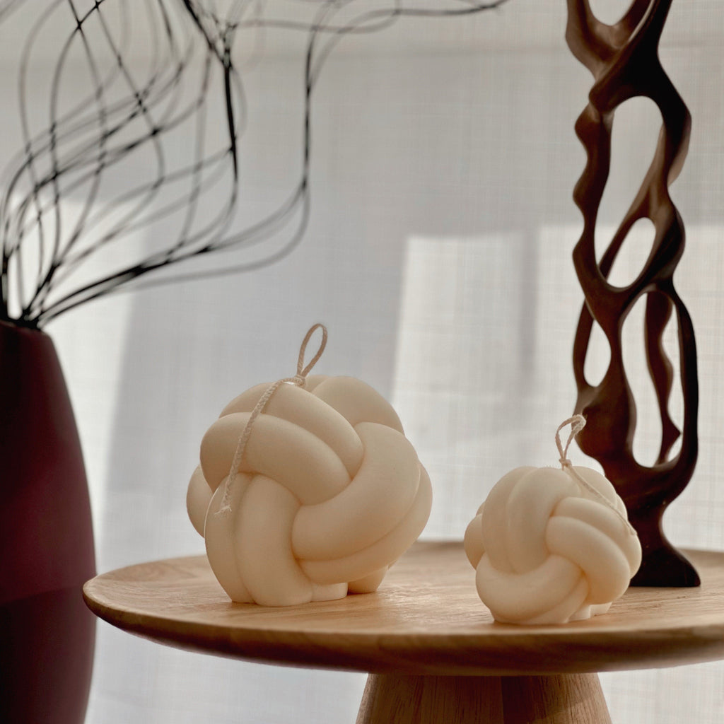 Minimalist knot soy candle in a twisted yarn ball shape, stylish neutral wax home decor