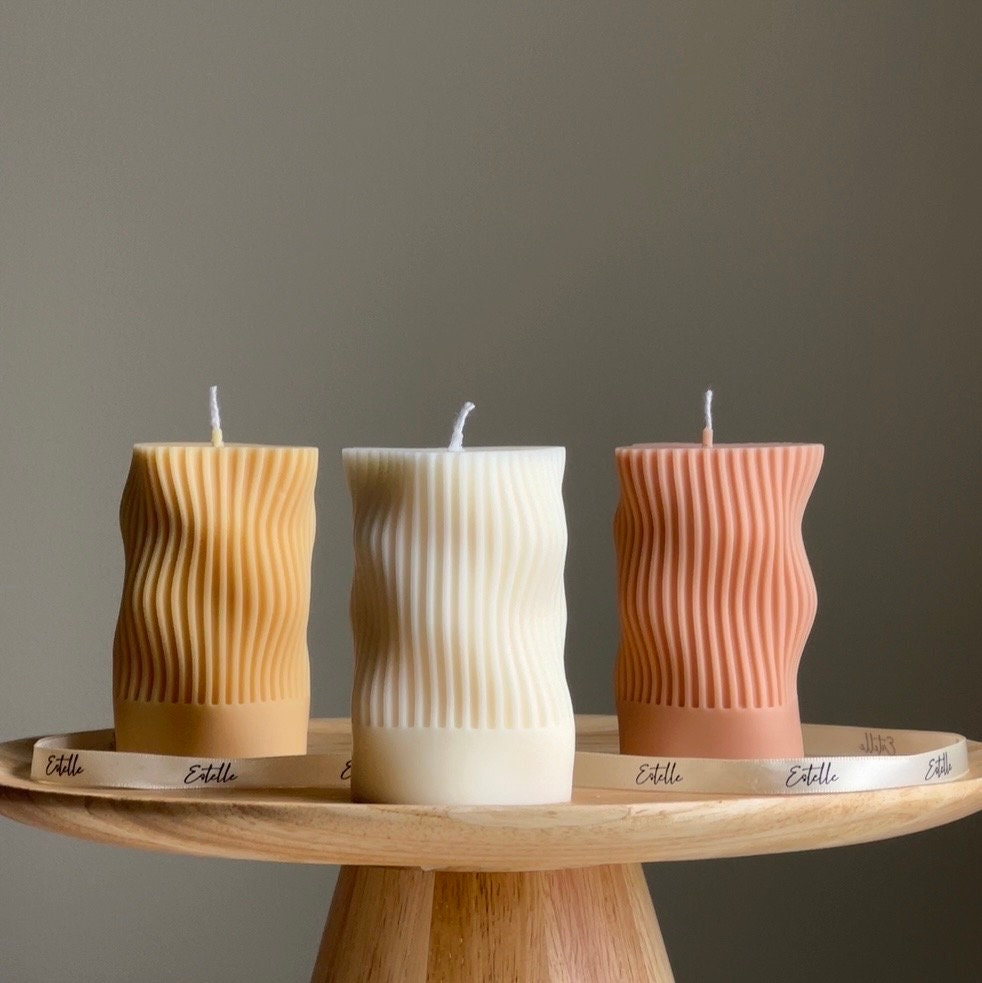Handmade ribbed wave column soy candle in a minimalist living space setting