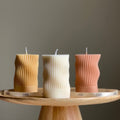 Handmade ribbed wave column soy candle in a minimalist living space setting