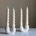 Minimalist handmade jesmonite double candlestick holder for taper candles on a modern dining table