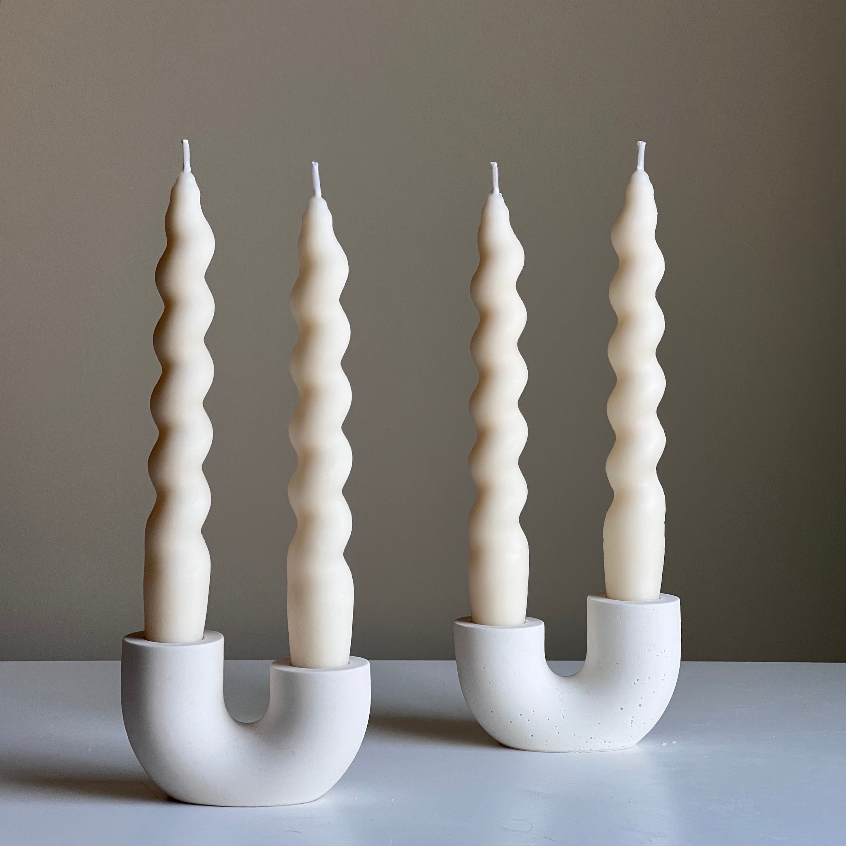 Minimalist handmade jesmonite double candlestick holder for taper candles on a modern dining table