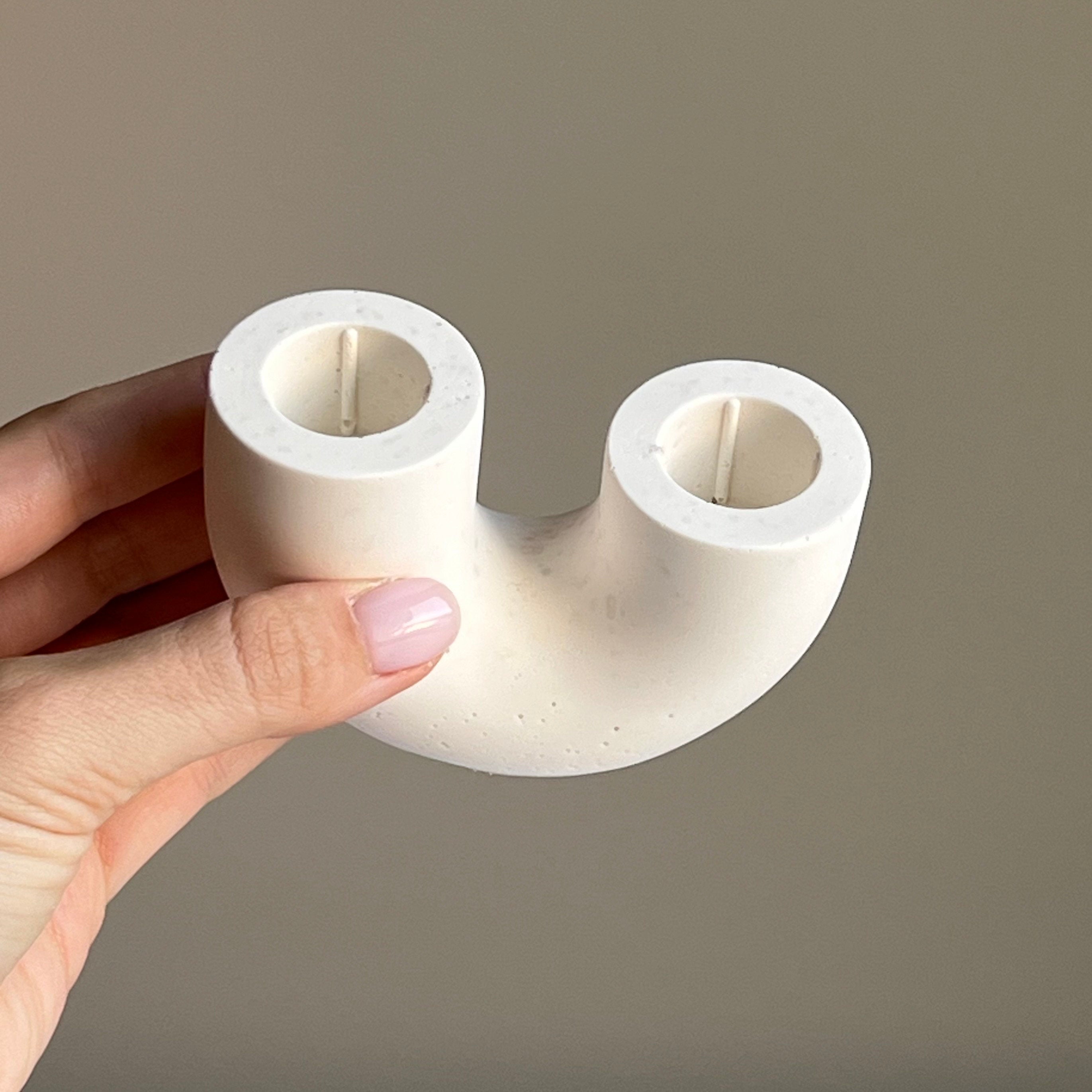 Minimalist handmade jesmonite double candlestick holder for taper candles on a modern dining table — view 3