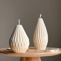 Origami lantern candle made of white geometric soy wax styled as minimalist home decor