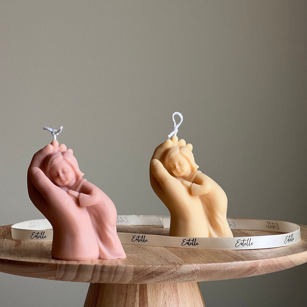 Handmade baby in hand sculptural soy wax candle in neutral tones for nursery room decor