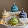Swirl Christmas bauble soy candle, handmade decorative festive wax centerpiece with a textured finish.