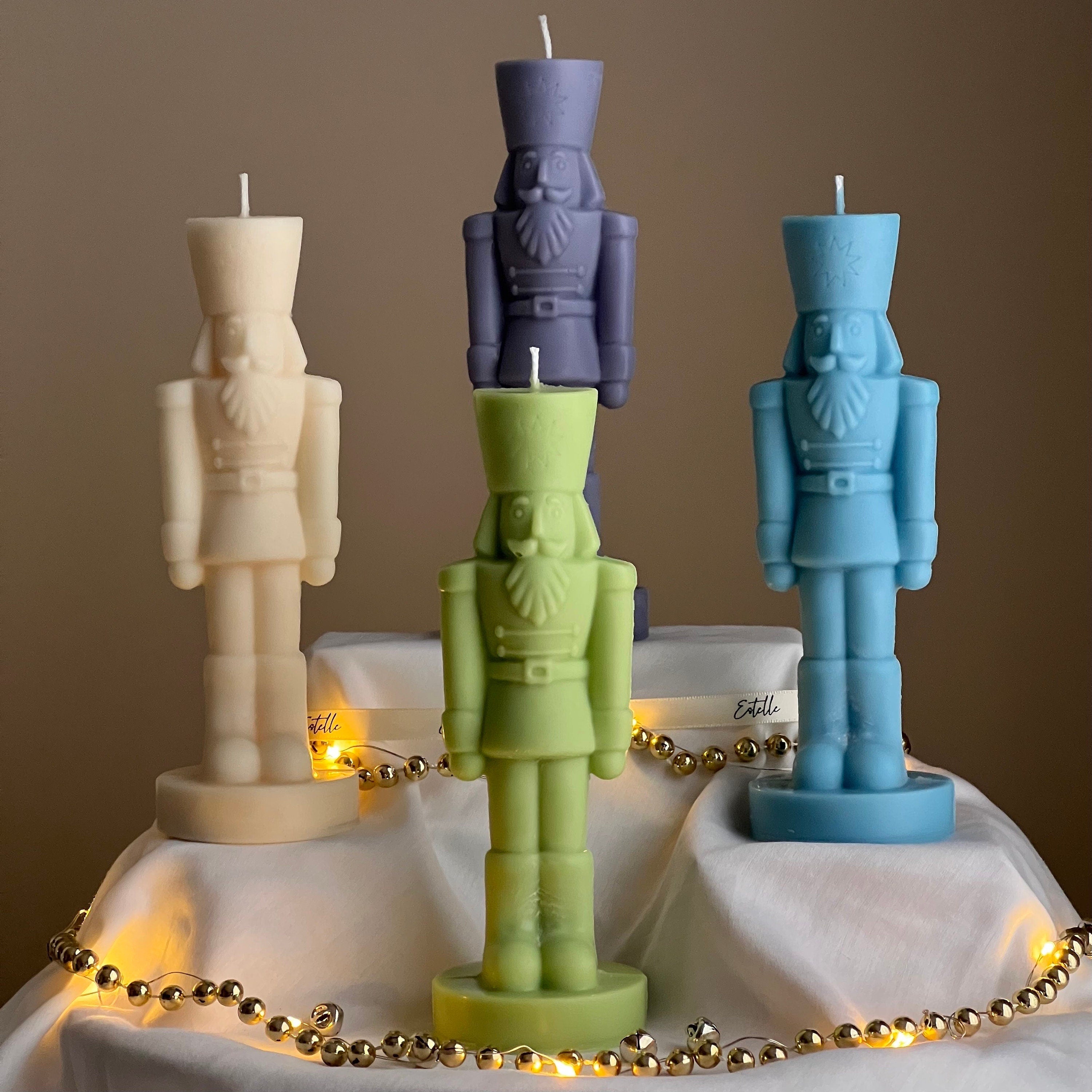 Handmade sculptural nutcracker candle made of solid soy wax for festive Christmas home decor displays