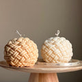 Large handmade yarn ball candle made of vegan soy wax in a cozy home decor setting