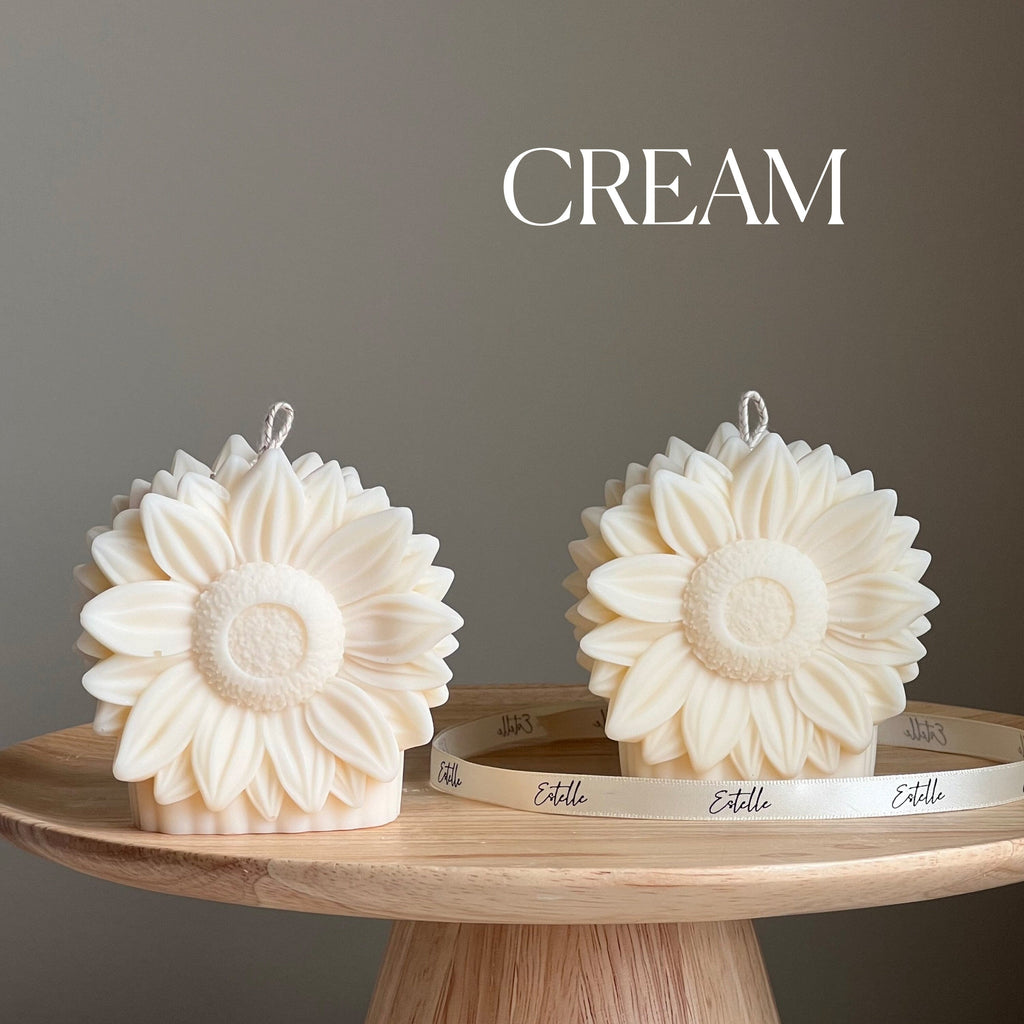Handmade yellow sunflower shaped decorative pillar candle made from vegan soy wax on a table — view 3