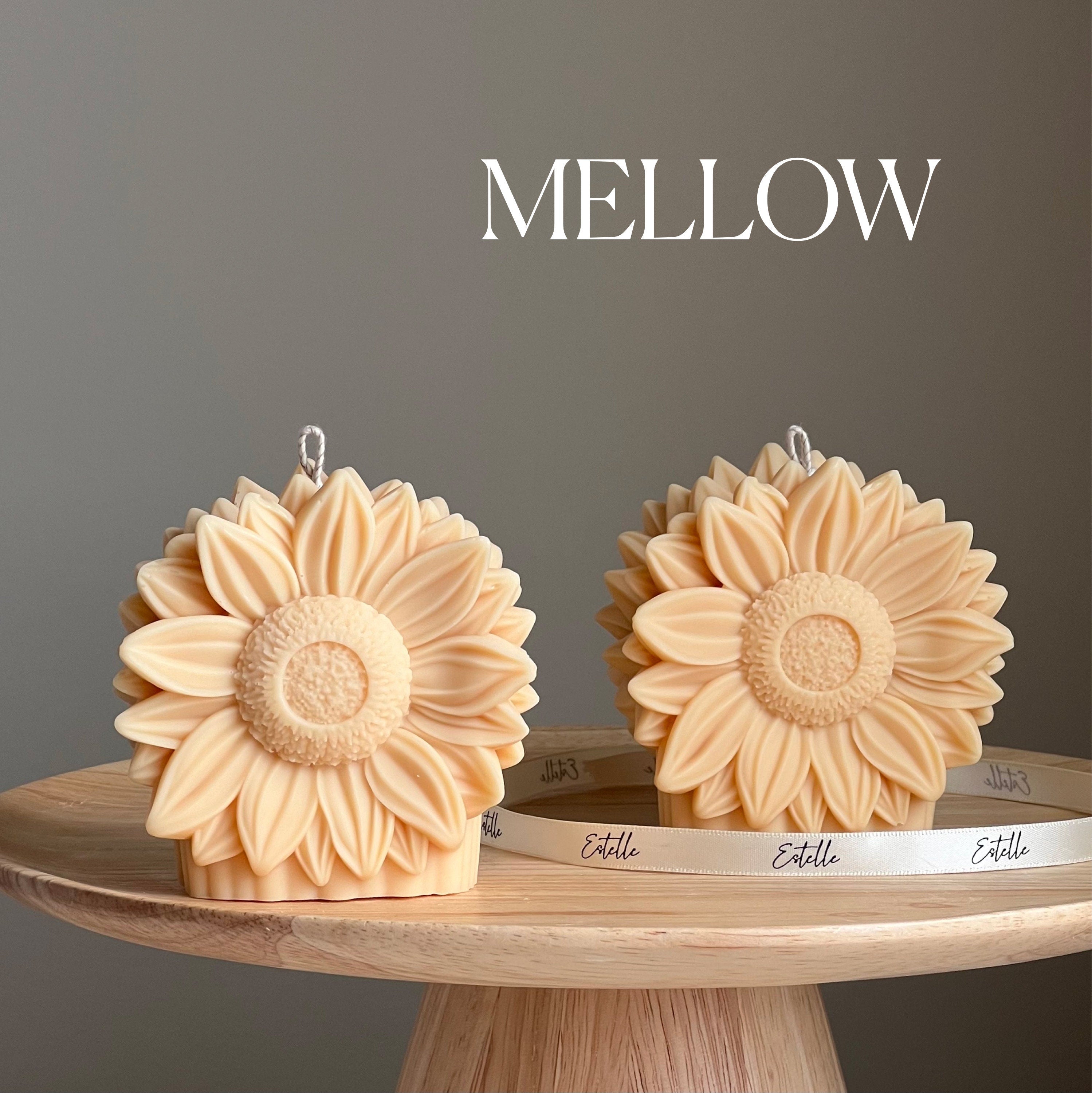 Handmade yellow sunflower shaped decorative pillar candle made from vegan soy wax on a table — view 4