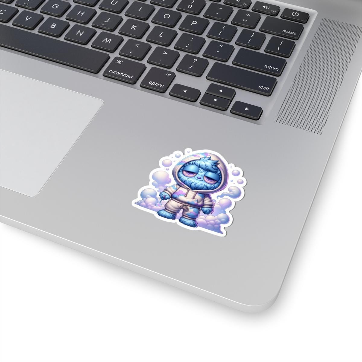Glossy pastel vinyl sticker of a fluffy blue monster in a cloud hoodie holding an orb — view 3