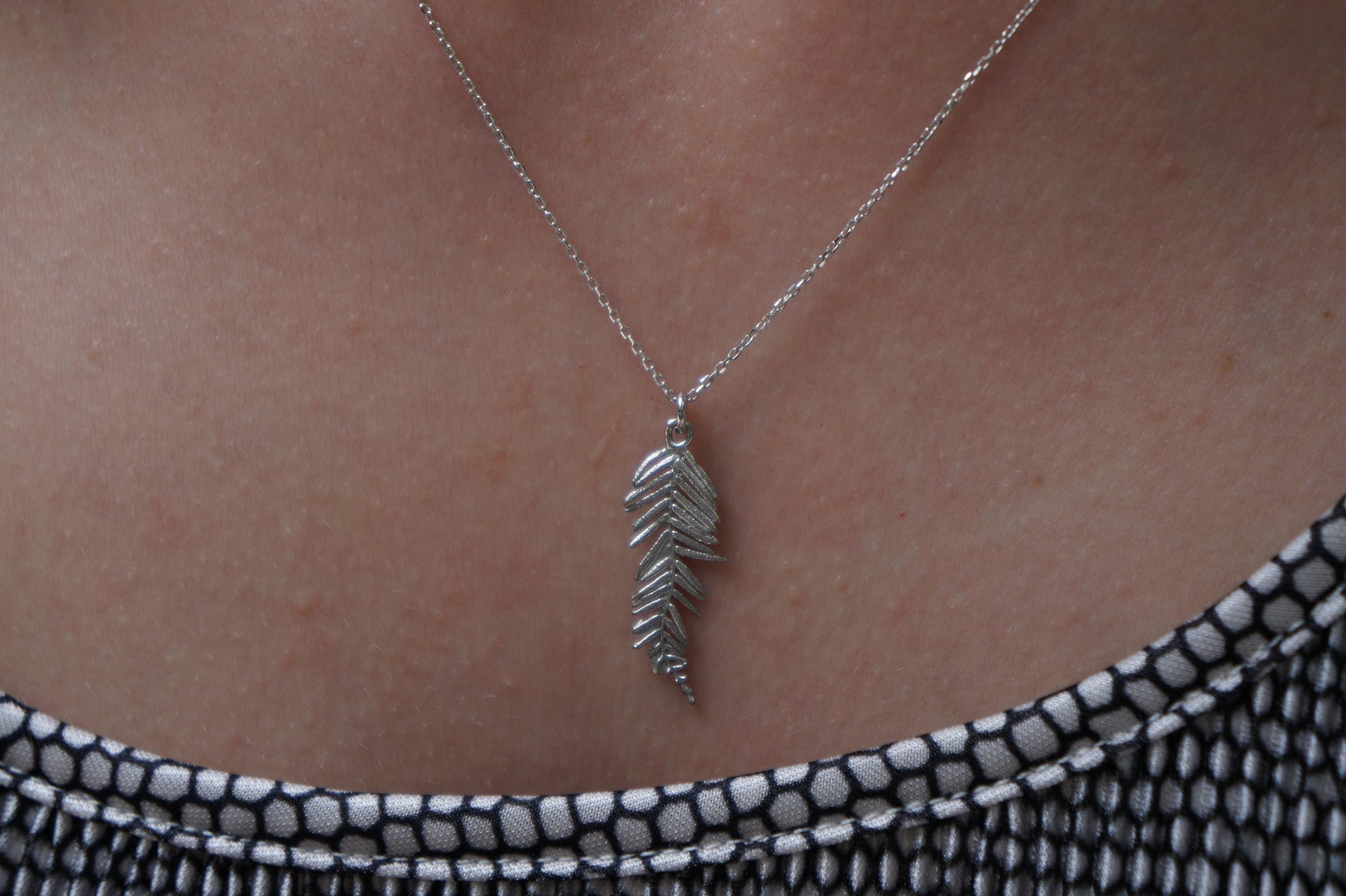 Gold-plated acacia leaf pendant necklace on an adjustable black rhodium-plated sterling silver chain. — view 2