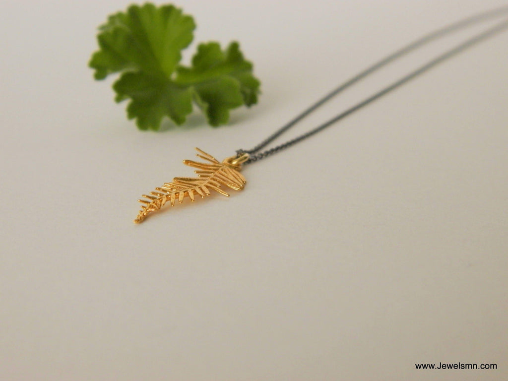 Gold-plated acacia leaf pendant necklace on an adjustable black rhodium-plated sterling silver chain. — view 4