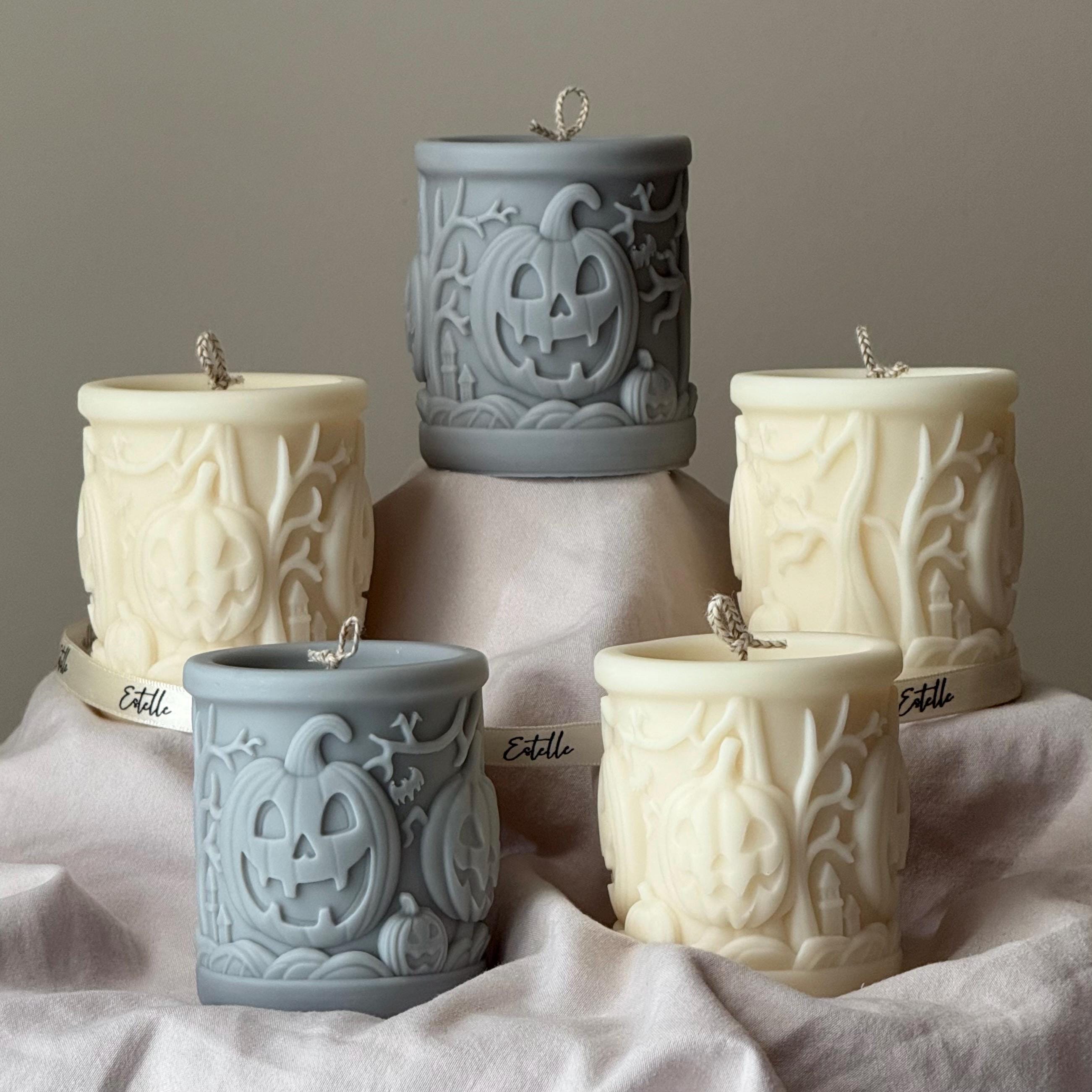 Scary pumpkin pillar candle made of soy blend wax in autumn home decor setting