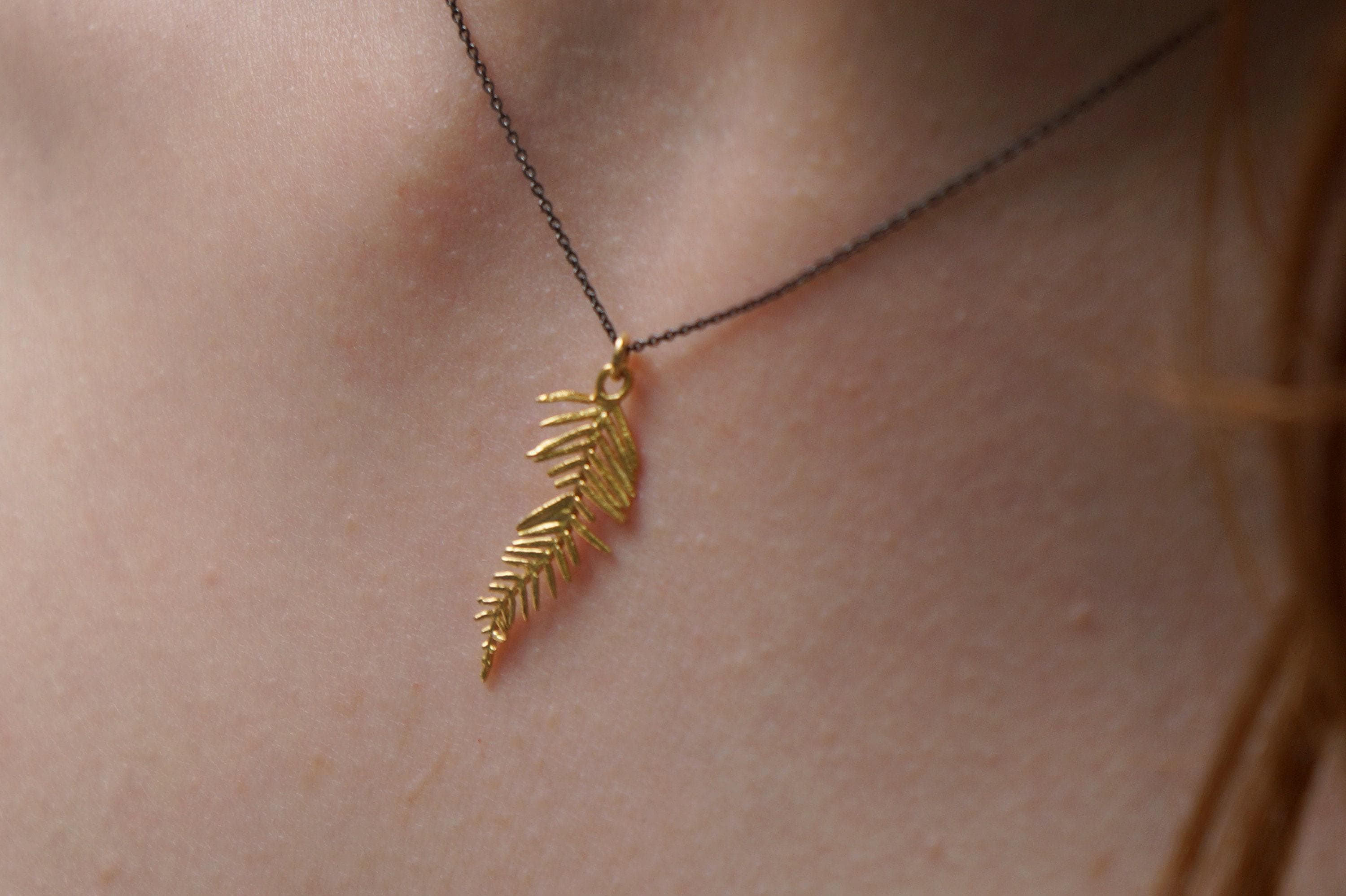Gold-plated acacia leaf pendant necklace on an adjustable black rhodium-plated sterling silver chain. — view 3