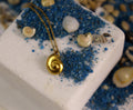 Gold sea shell necklace pendant crafted from 14K gold-plated sterling silver on a delicate chain