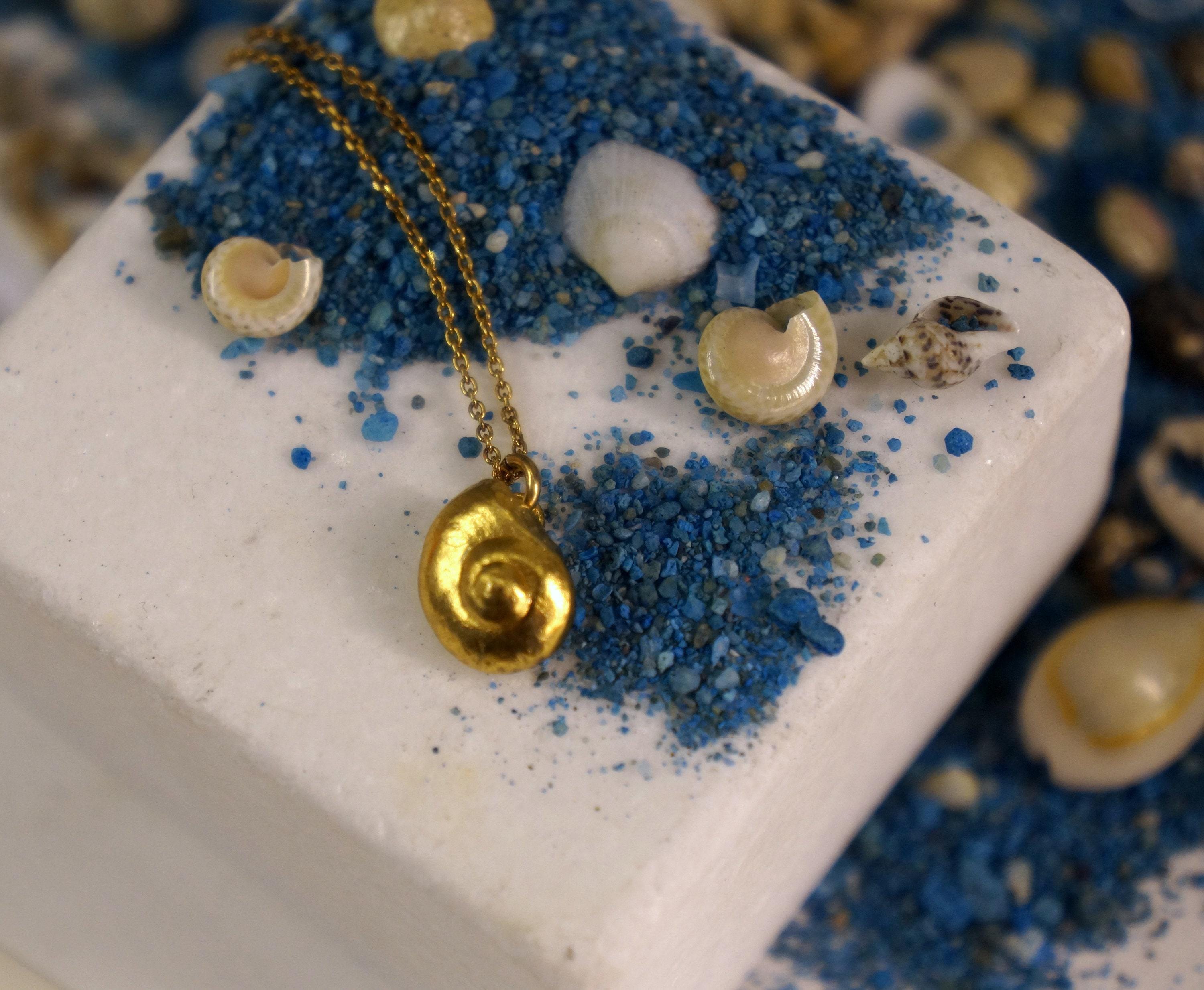 Gold sea shell necklace pendant crafted from 14K gold-plated sterling silver on a delicate chain