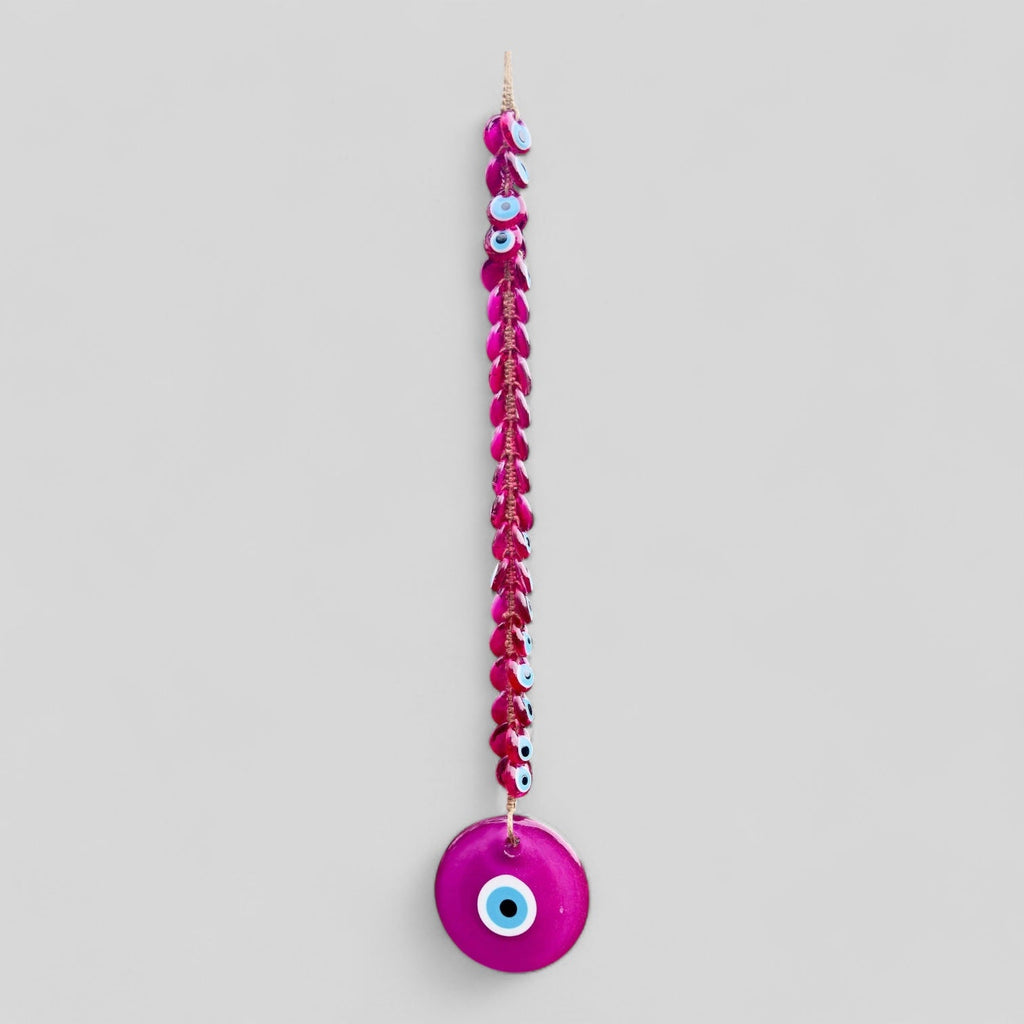 Pink evil eye wall hanging decor with 41 handblown glass beads and intricate macrame detailing.