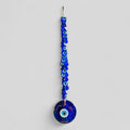 Large blue glass evil eye wall hanging with 40 smaller macrame beads for home protection.