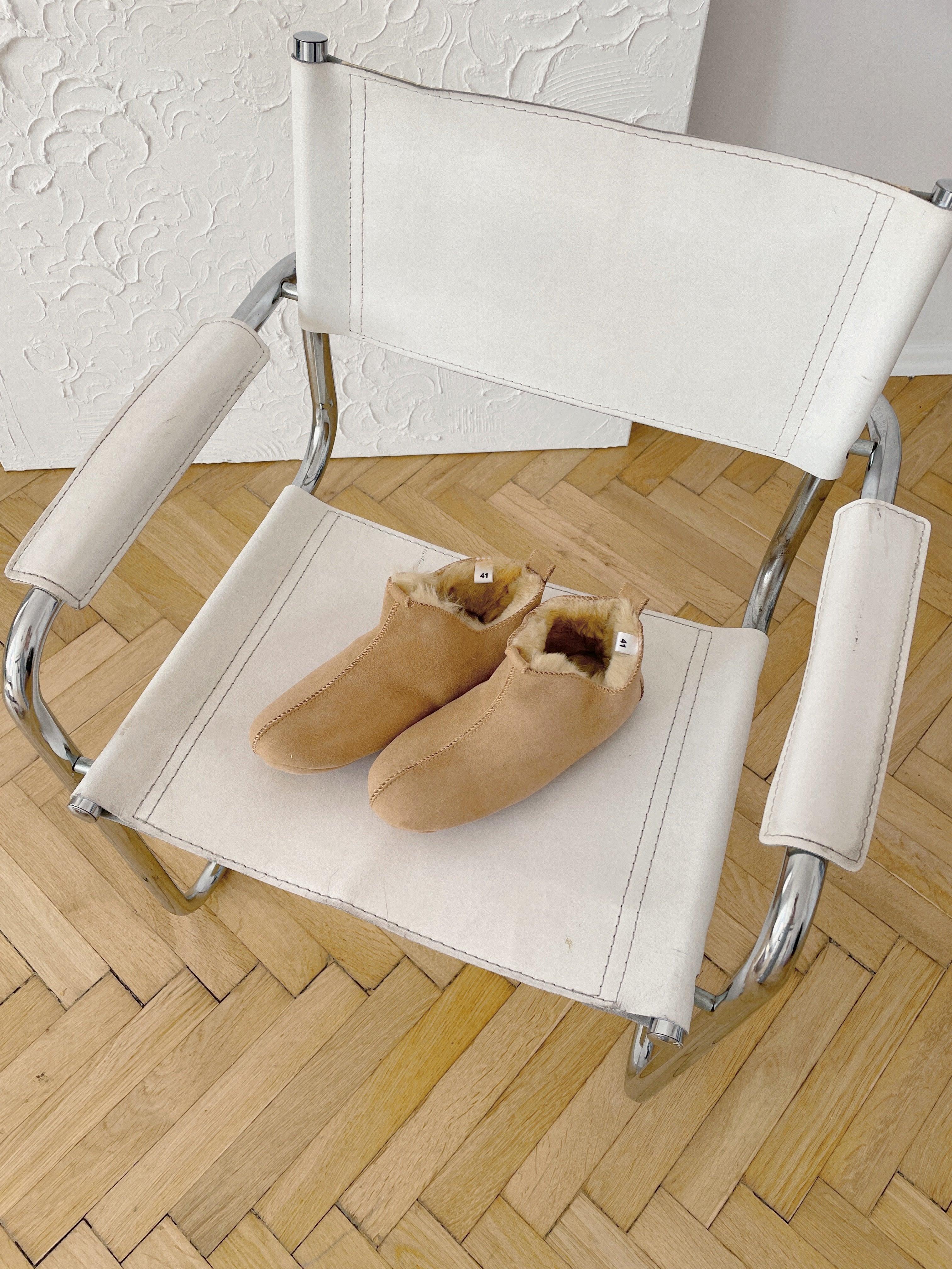 Beige adult natural sheepskin boots with genuine leather sole on a clean background — view 3