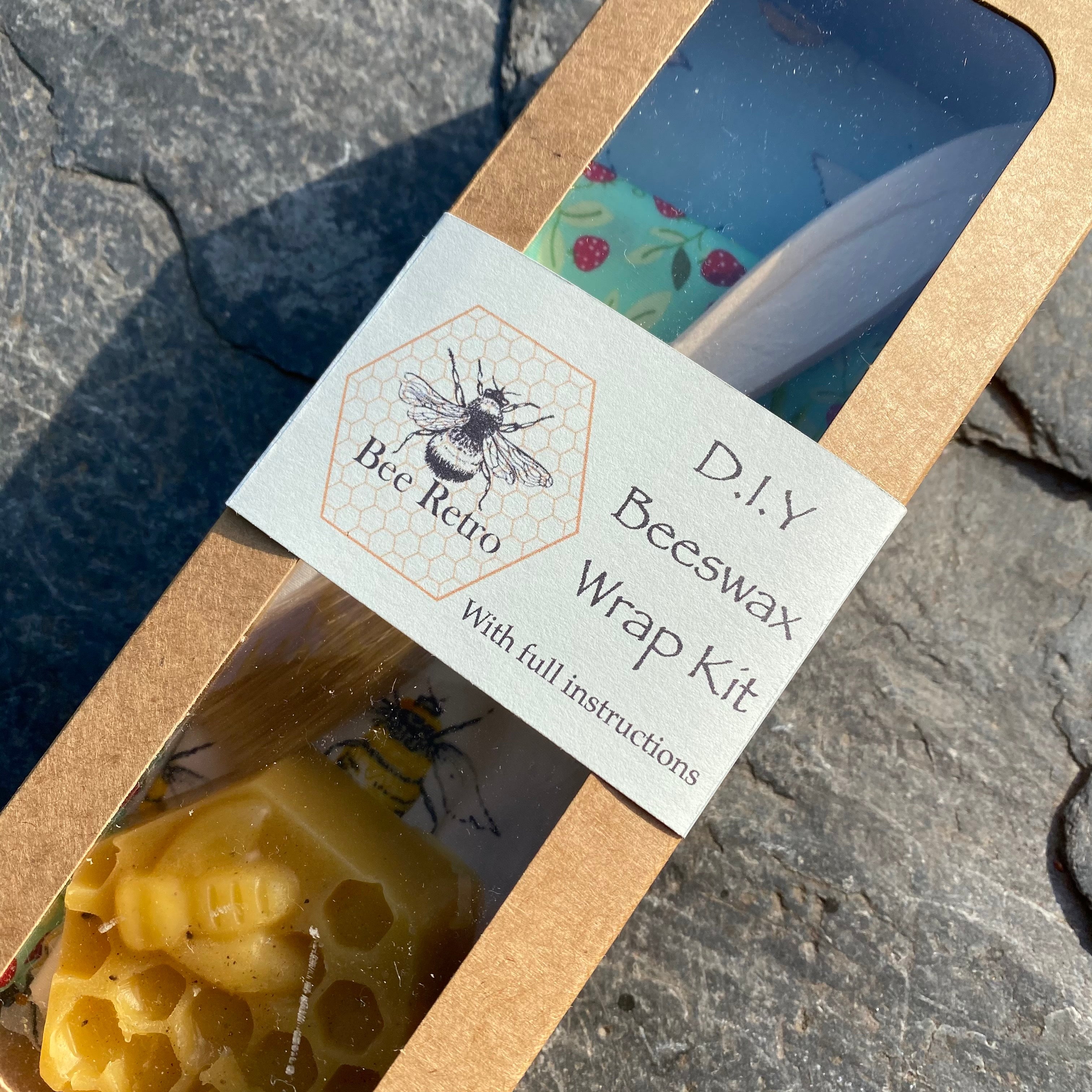 Complete DIY beeswax food wrap kit with cotton fabric, wax block, brush, and instruction manual