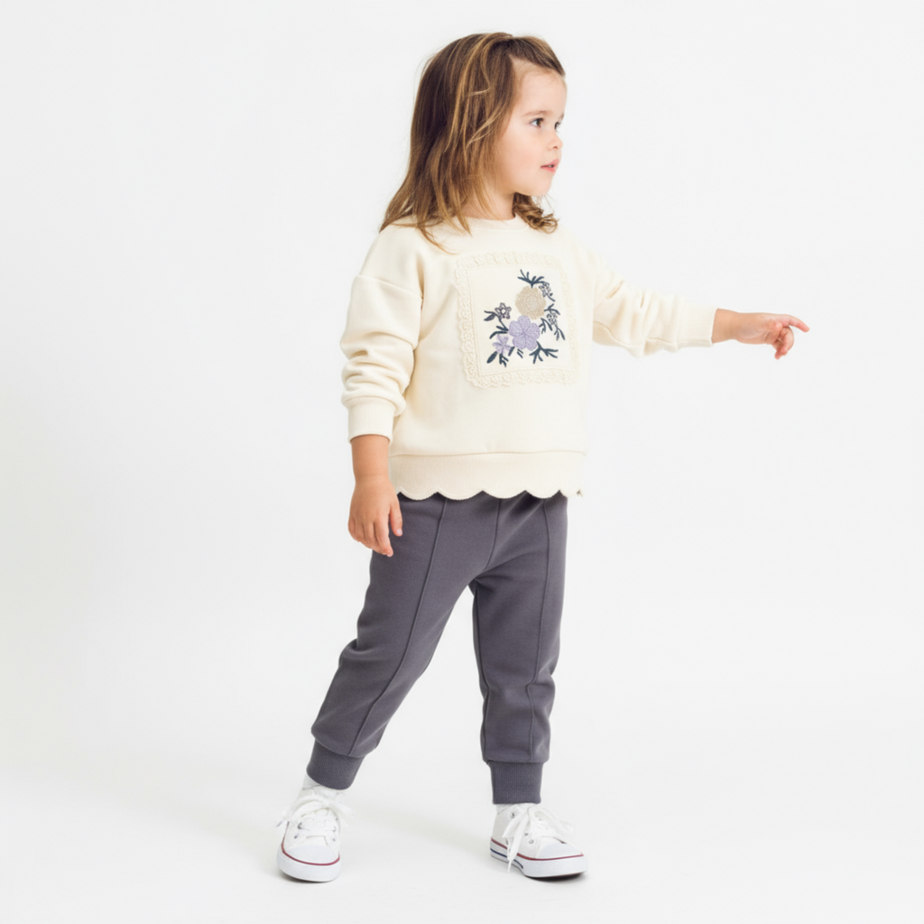 Cotton two-piece baby girls jogger set featuring floral embroidery, scalloped hem, and elastic waist pants.