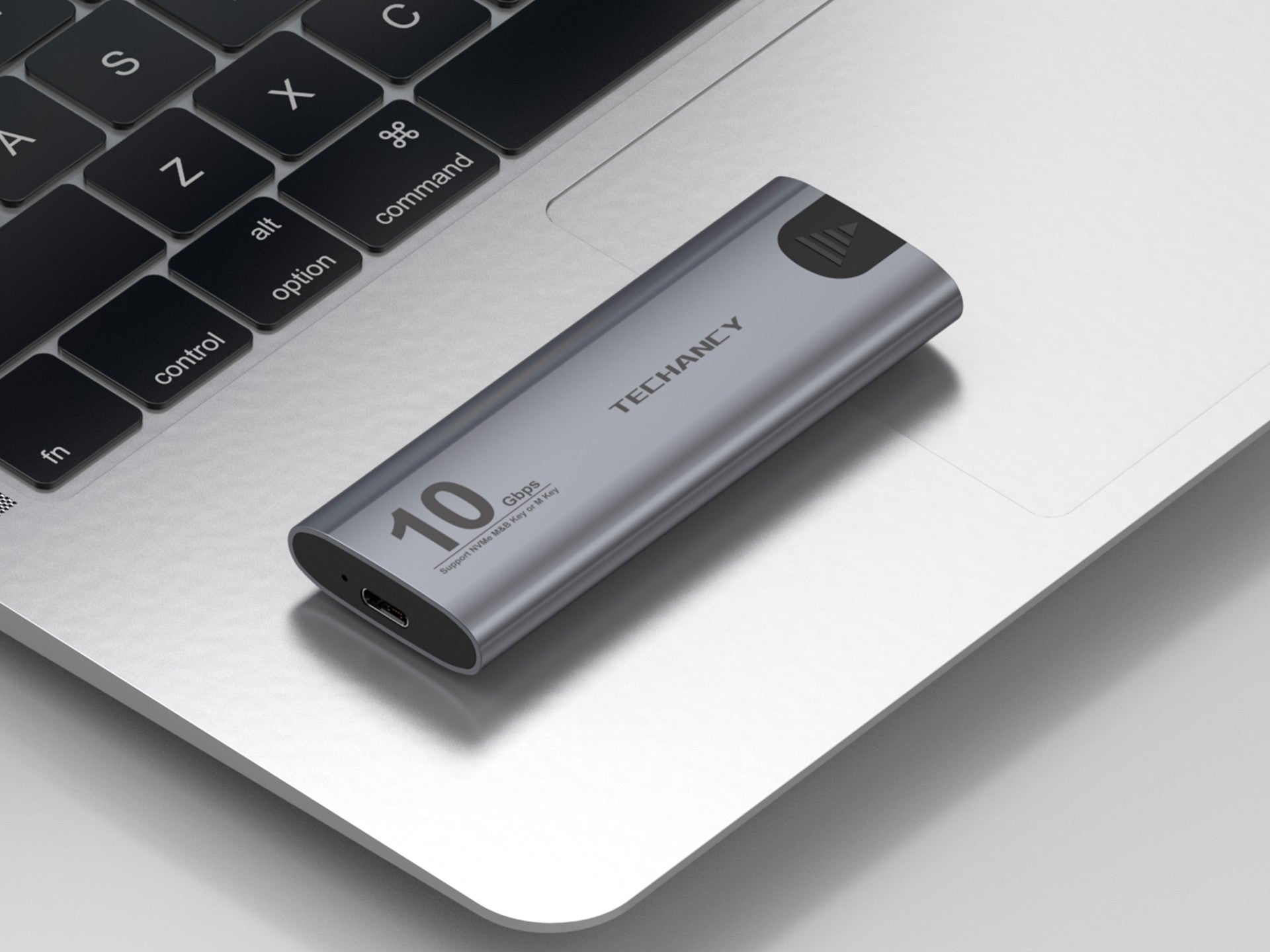 Grey portable aluminum M.2 NVMe SSD enclosure with USB-C data transfer cable — view 3