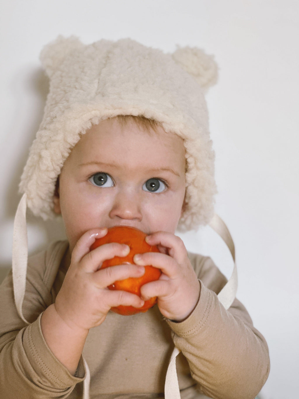 Polar white woolen baby hat with teddy texture, bear ears, and long secure tie strings — view 2