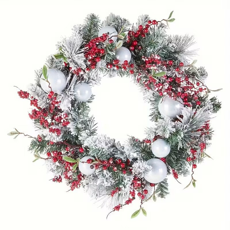 Artificial green Christmas wreath decorated with vibrant red berries and white balls for holiday doors