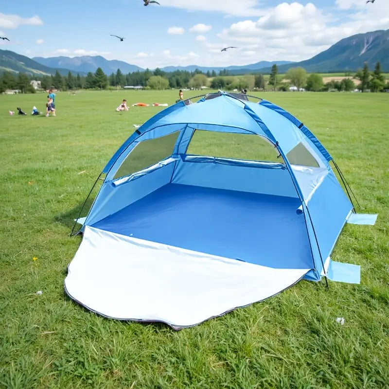 Blue pop-up beach tent sun shelter with extendable footprint and mesh windows on sand. — view 4