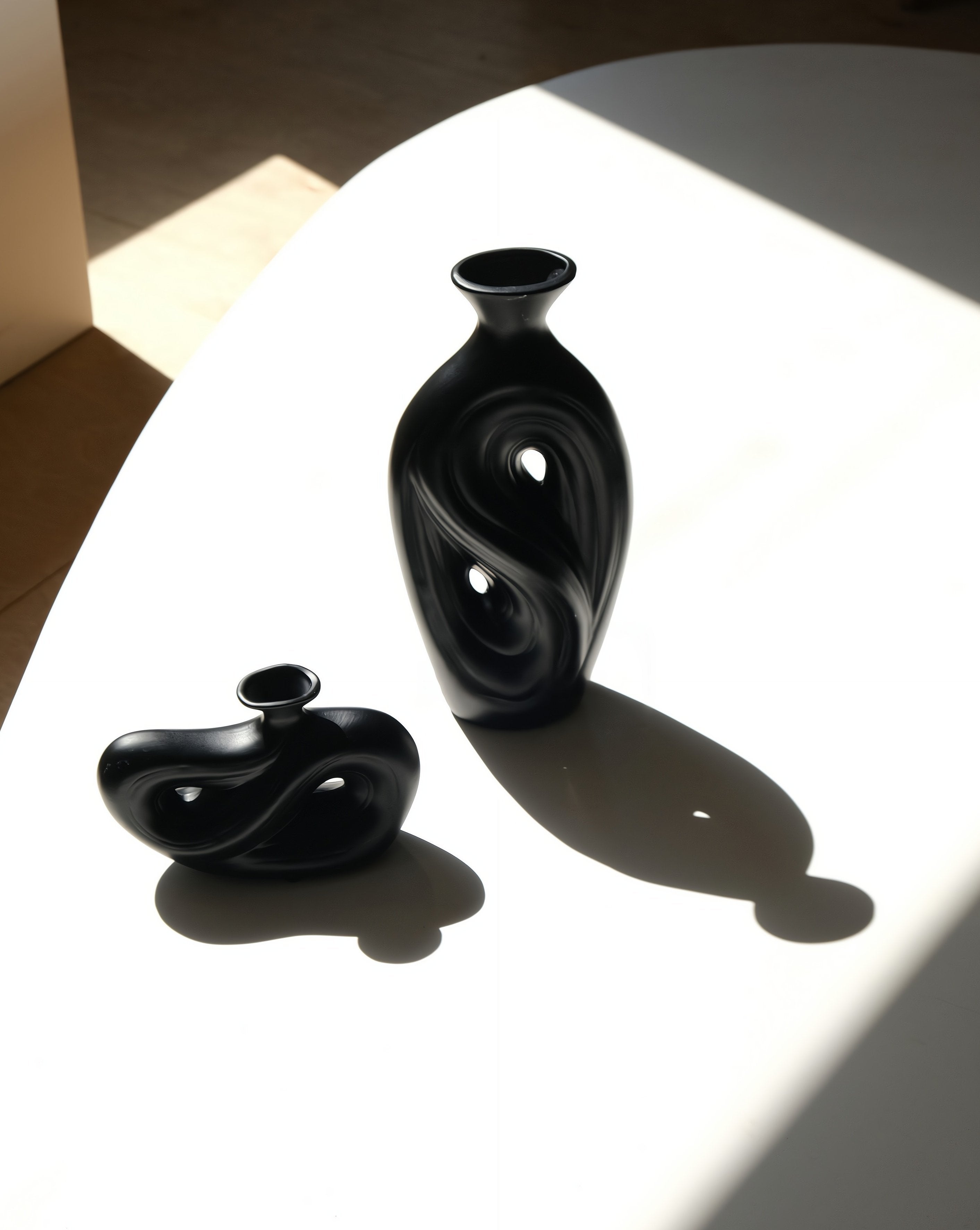 Handmade contemporary abstract black ceramic flower vase with an irregular decorative shape — view 2