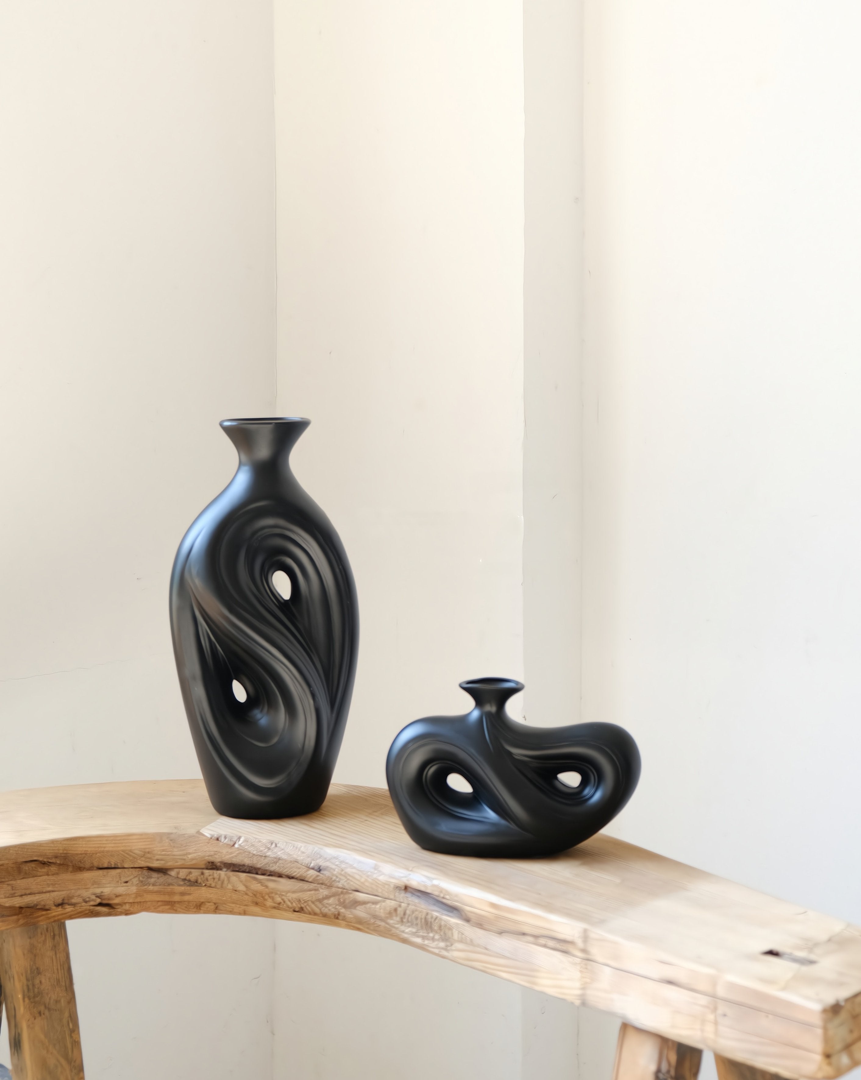 Handmade contemporary abstract black ceramic flower vase with an irregular decorative shape
