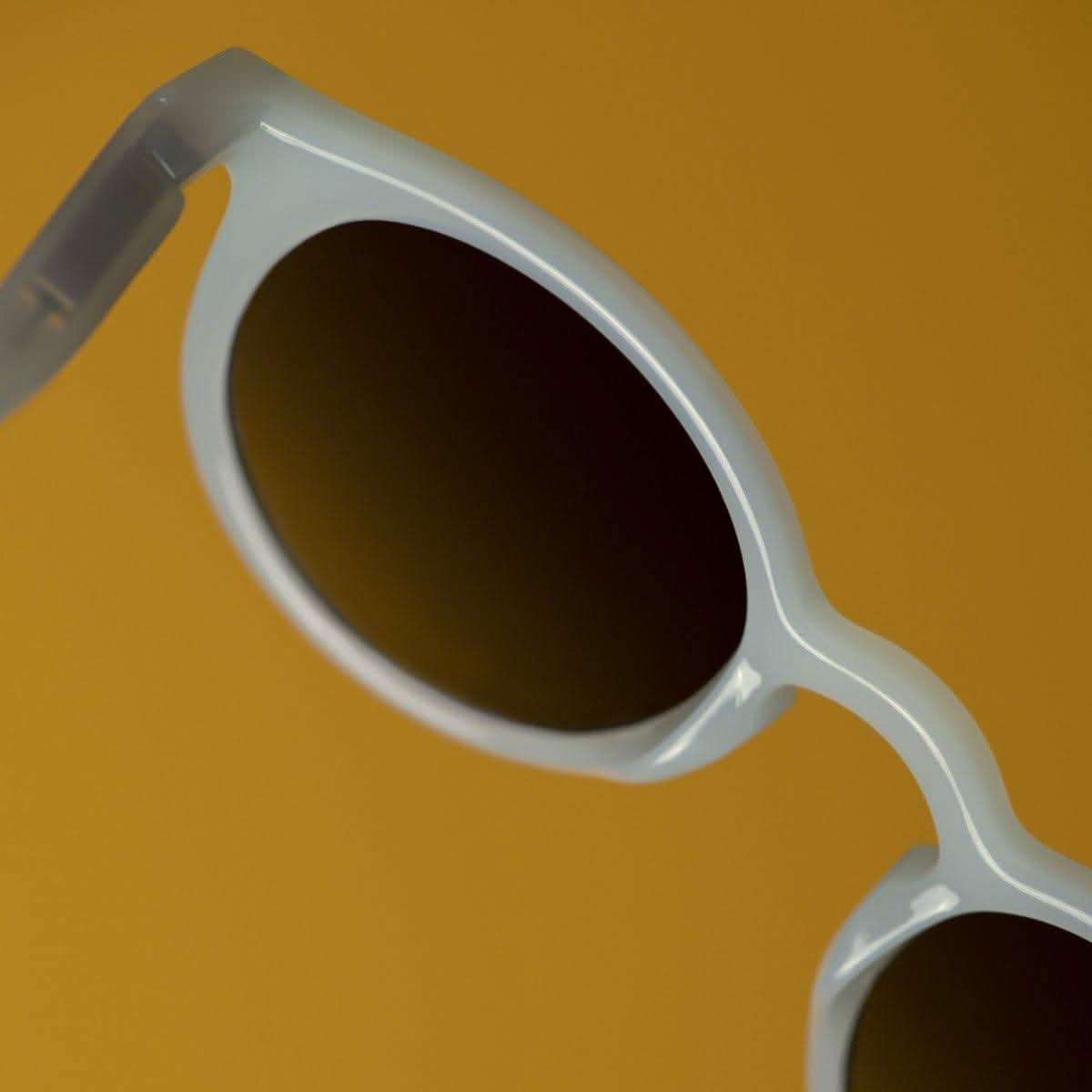Translucent Morning Light baby sunglasses with flexible frame and silicone head strap on white background — view 2