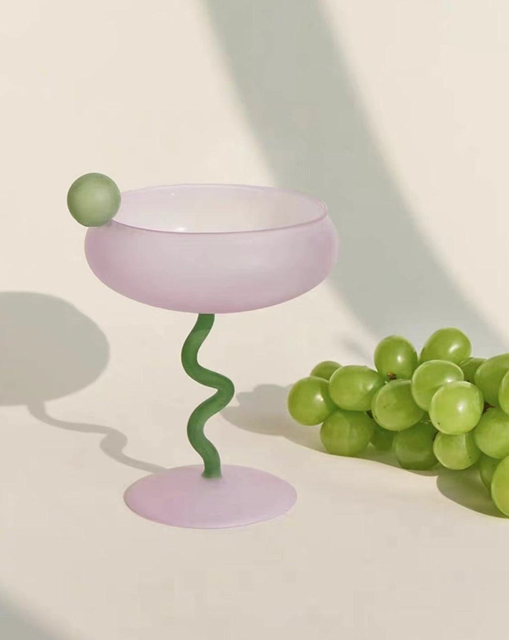 Colorful mouth-blown Jelly Bean cocktail coupe glasses displayed on an elegant festive dining tabletop. — view 3