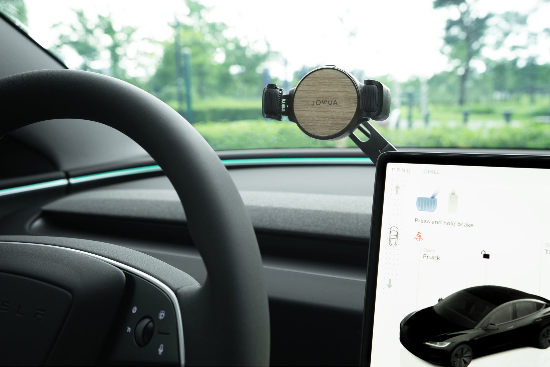 Invisible foldaway Qi2 wireless car charger mounted behind a touchscreen with adjustable metal arm — view 2