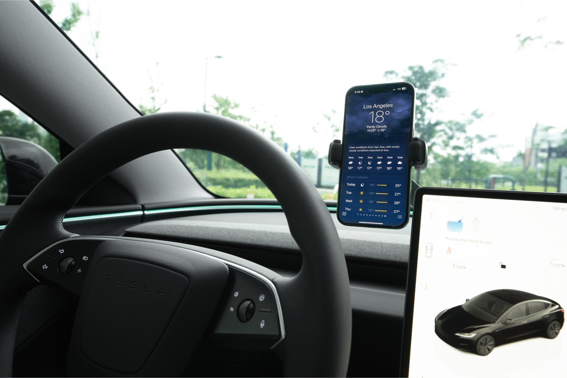 Invisible foldaway Qi2 wireless car charger mounted behind a touchscreen with adjustable metal arm — view 3