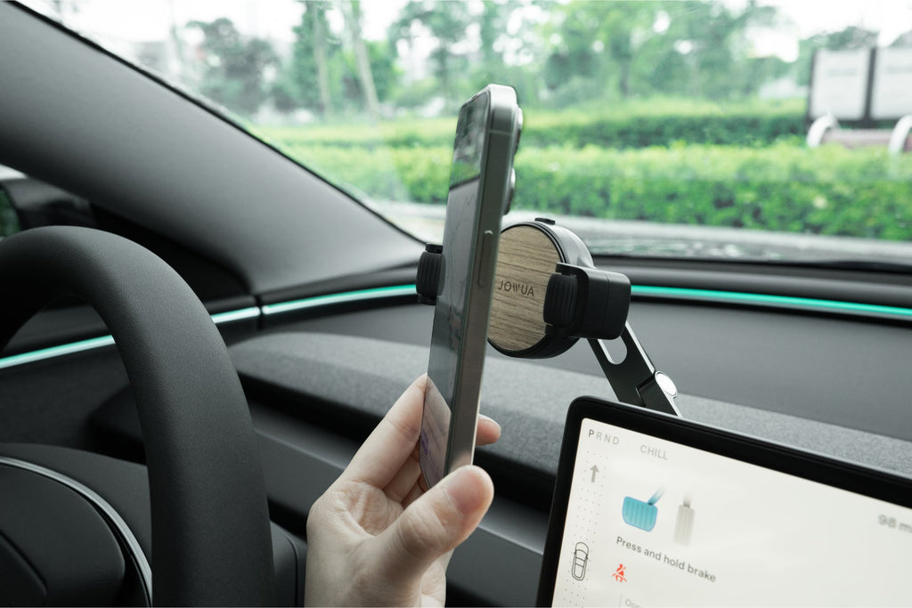 Invisible foldaway Qi2 wireless car charger mounted behind a touchscreen with adjustable metal arm — view 5