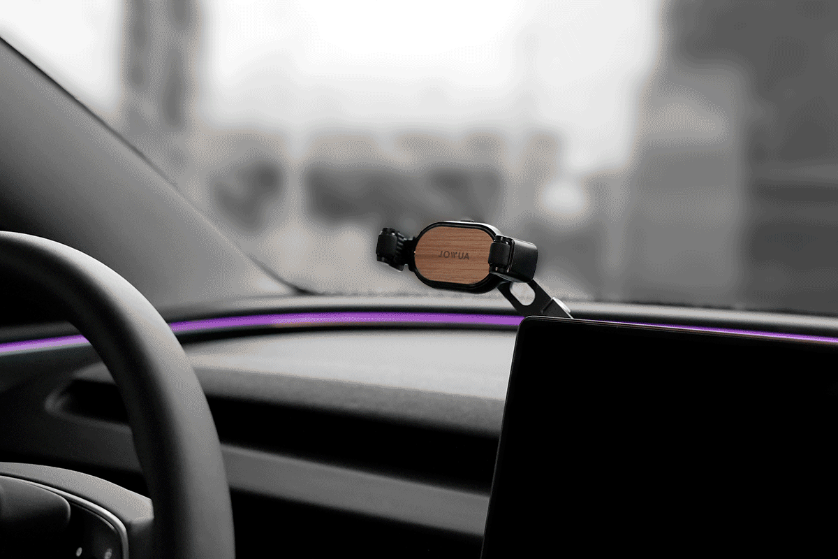 Retractable foldaway car mount with adjustable metal arm and silicone clamp holding a smartphone — view 2