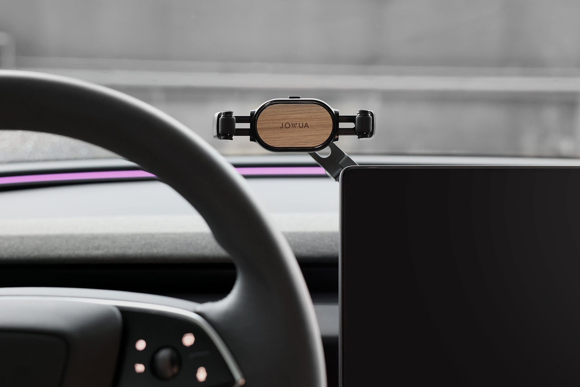 Retractable foldaway car mount with adjustable metal arm and silicone clamp holding a smartphone — view 4