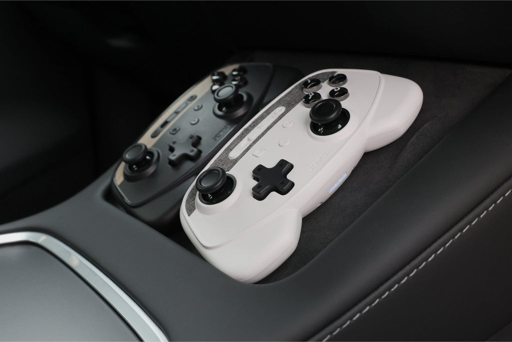 Black multi-device wireless gaming controller for Tesla with dual joysticks and wireless charging capability — view 5