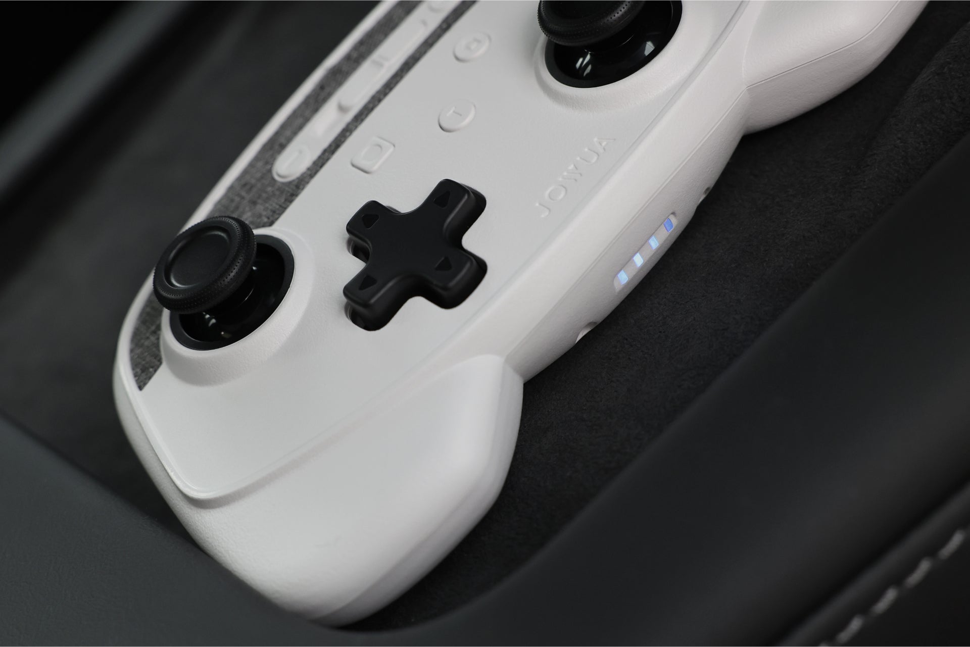 Two wireless game controllers and metallic 4-port USB dashcam hub for Tesla interior — view 5