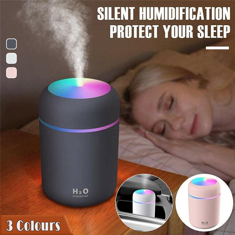 Portable USB car humidifier and essential oil diffuser emitting cool mist on a desk